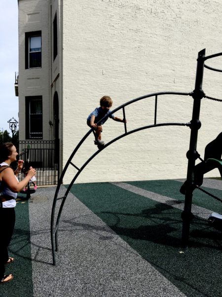 Mom is smiling, encouraging him, yet reaching out.  Letting our children out of our reach can be a challenge!